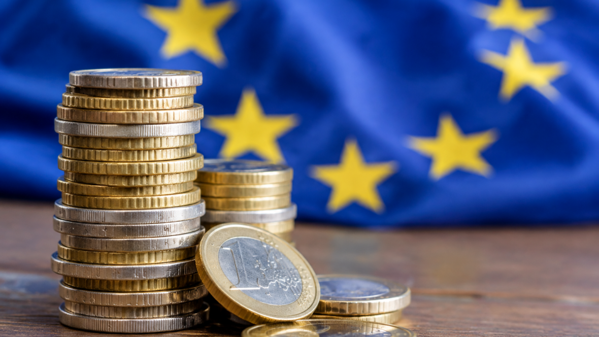 stacked euro coins with EU flag background