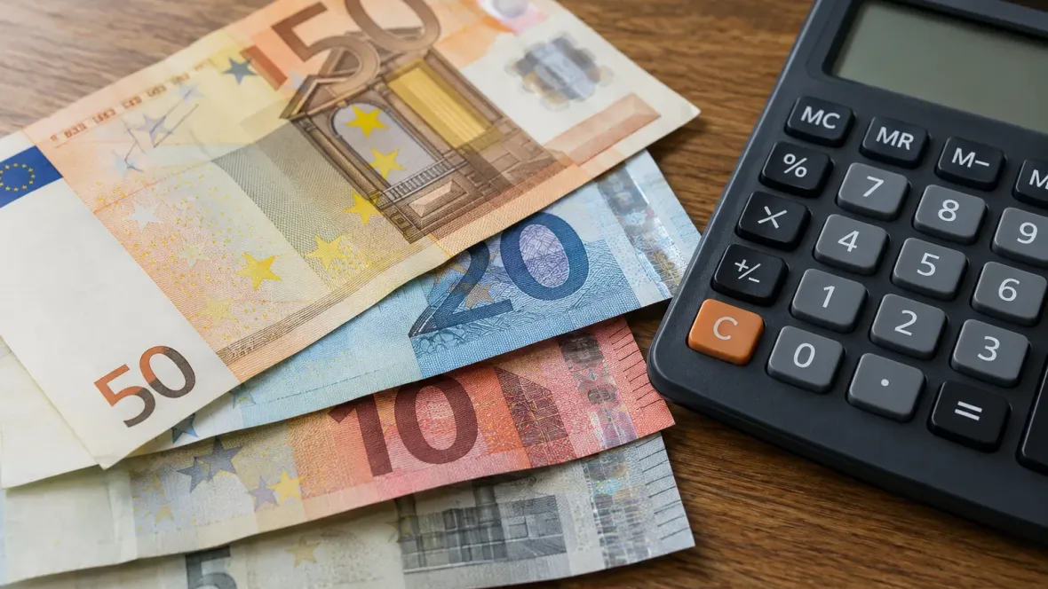 close-up euro banknotes and calculator on table