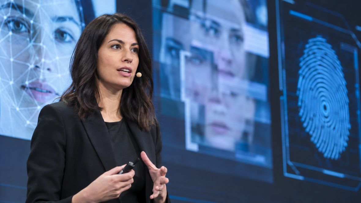 speaker presenting AI cybersecurity threats on stage