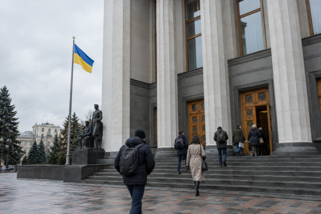government building entrance with people and flag